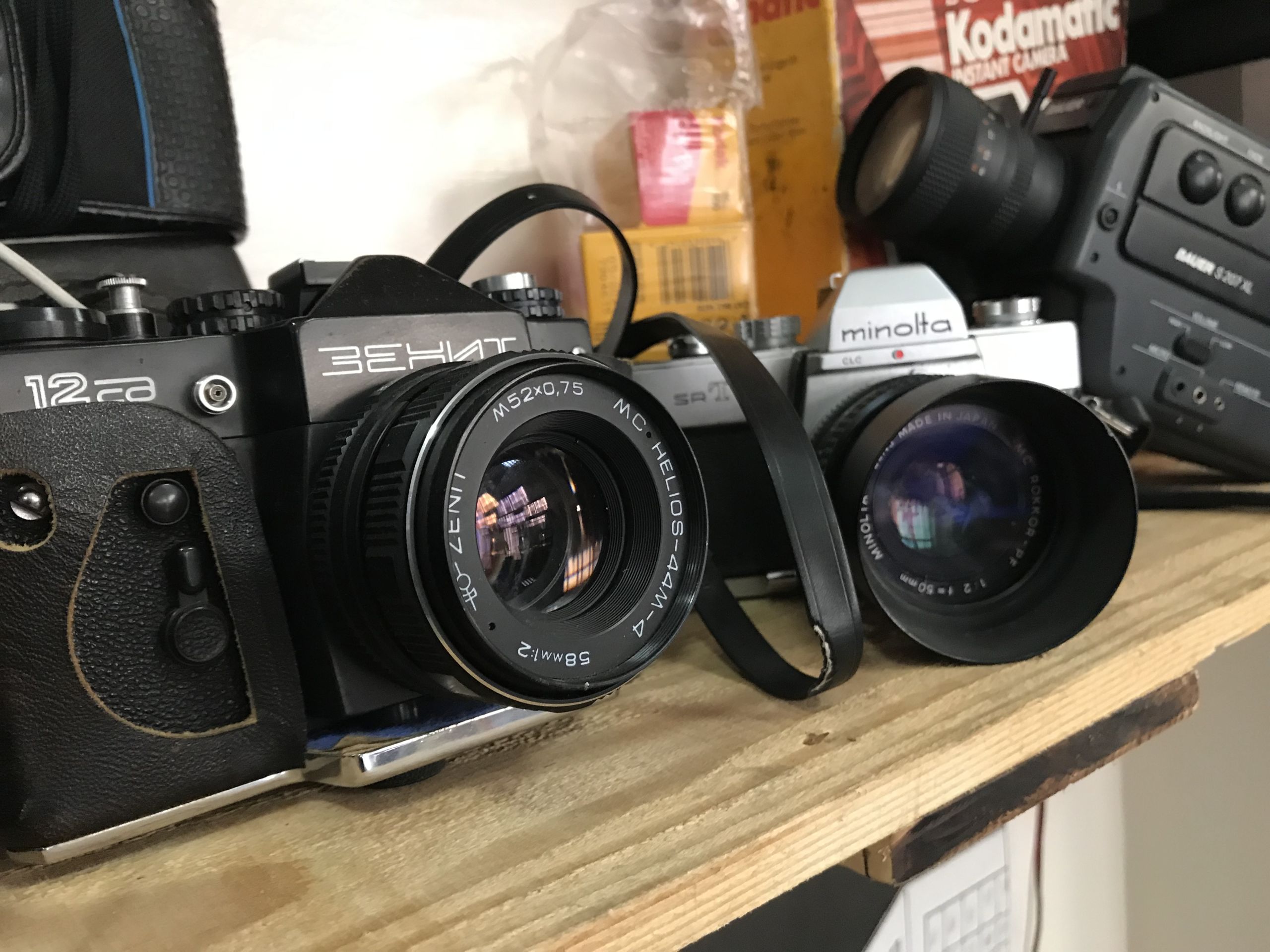 A second shelf filled with cameras and Polaroids.