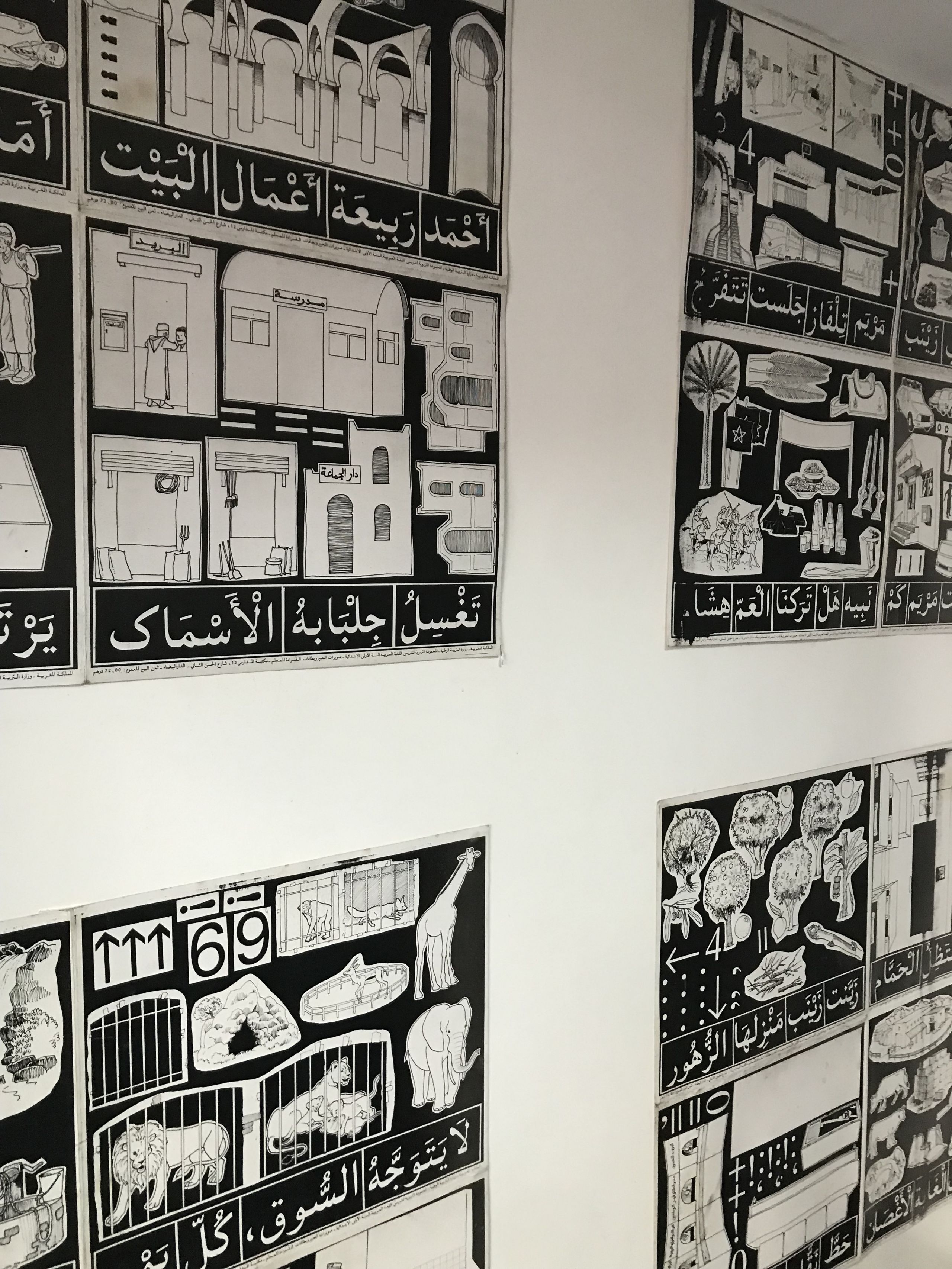Black and white posters used to educate Moroccan students in the 1990s hung on the walls in the tattoo studio.